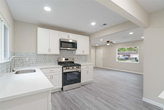 9409 Fairland Dr, Houston, TX 77051 - kitchen with stainless steel appliances, a sink, tasteful backsplash, ceiling fan, and recessed lighting