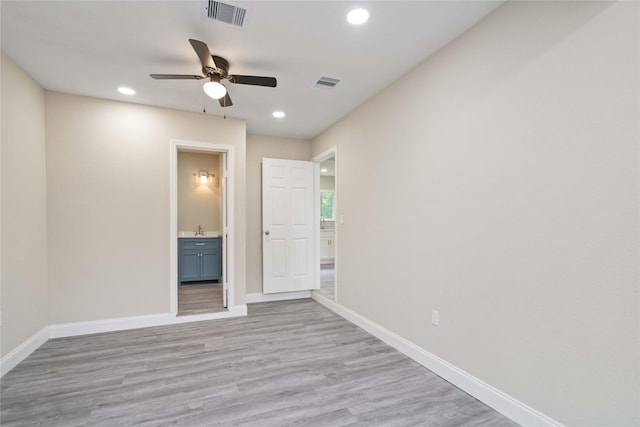 9409 Fairland Dr, Houston, TX 77051 - empty room with ceiling fan, baseboards, recessed lighting, light wood-style flooring, and a sink