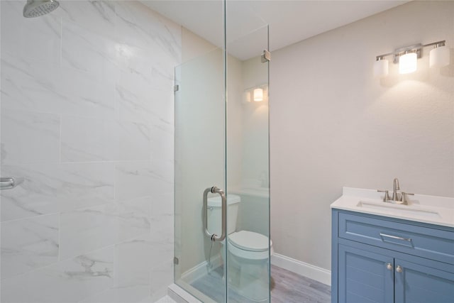 9409 Fairland Dr, Houston, TX 77051 - bathroom with a stall shower, vanity, wood finished floors, and baseboards