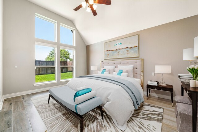 13909 Morgan Bay Dr, Pearland, TX 77584 - bedroom with vaulted ceiling, light wood-type flooring, baseboards, and a ceiling fan