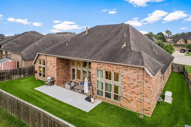 13909 Morgan Bay Dr, Pearland, TX 77584 - rear view of house with a shingled roof, a patio, and brick siding