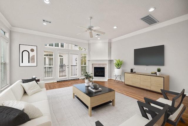 920 Asbury St, Houston, TX 77007 - living area with a ceiling fan, wood finished floors, recessed lighting, crown molding, and a fireplace