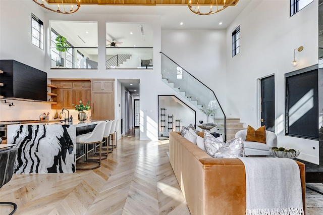 1030 Voight St, Houston, TX 77009 - living area featuring a high ceiling, a chandelier, stairs, and a ceiling fan