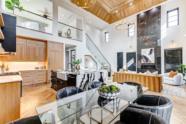 1030 Voight St, Houston, TX 77009 - dining room featuring a high ceiling, wood ceiling, a chandelier, stairway, and recessed lighting