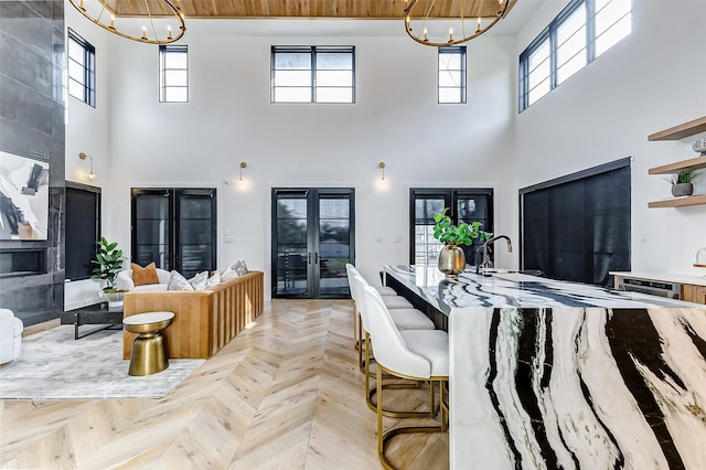 1030 Voight St, Houston, TX 77009 - living area with a chandelier, a high ceiling, french doors, and healthy amount of natural light