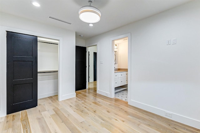 1030 Voight St, Houston, TX 77009 - unfurnished bedroom with light wood finished floors, a closet, baseboards, recessed lighting, and ensuite bath