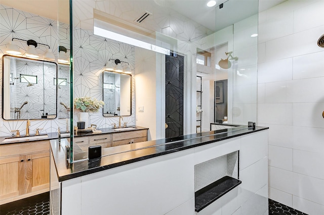 1030 Voight St, Houston, TX 77009 - full bathroom with a walk in shower, double vanity, and tile walls