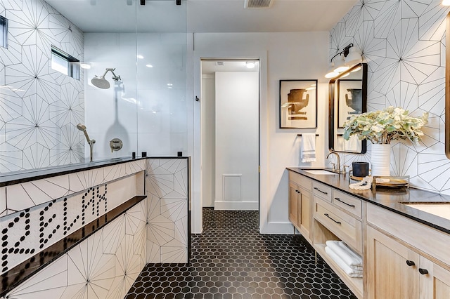 1030 Voight St, Houston, TX 77009 - bathroom featuring double vanity, walk in shower, and baseboards