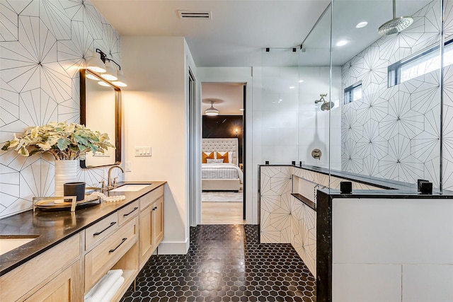 1030 Voight St, Houston, TX 77009 - full bath with ensuite bathroom, tile walls, double vanity, walk in shower, and tile patterned floors