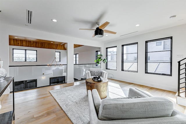 1030 Voight St, Houston, TX 77009 - living room featuring a ceiling fan, recessed lighting, and light wood-style flooring