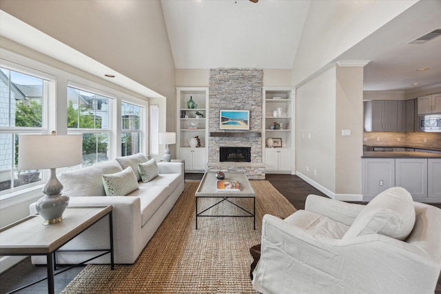 2409 Ralph St Unit A, Houston, TX 77006 - living area featuring baseboards, dark wood-style flooring, high vaulted ceiling, built in shelves, and a stone fireplace