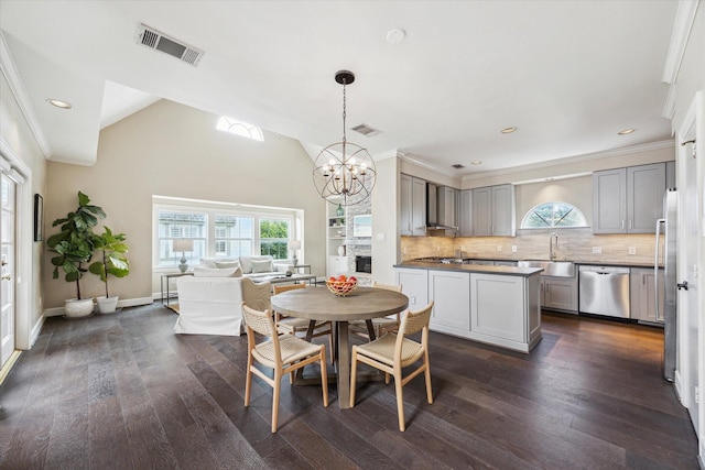 2409 Ralph St Unit A, Houston, TX 77006 - dining area featuring a chandelier, plenty of natural light, dark wood-style flooring, recessed lighting, and crown molding