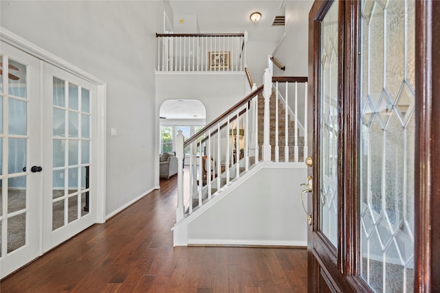 4019 Bellinger Way, Missouri City, TX 77459 - foyer entrance with french doors, arched walkways, hardwood / wood-style floors, and stairway