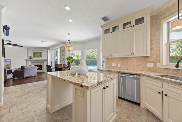 4019 Bellinger Way, Missouri City, TX 77459 - kitchen featuring stainless steel dishwasher, healthy amount of natural light, a sink, a kitchen island, and recessed lighting