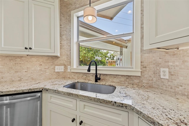 4019 Bellinger Way, Missouri City, TX 77459 - kitchen featuring stainless steel dishwasher, a sink, tasteful backsplash, white cabinets, and light stone counters