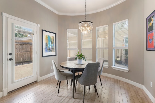 13207 Regency Oak Ln, Cypress, TX 77429 - dining space with a chandelier, light wood finished floors, baseboards, and ornamental molding