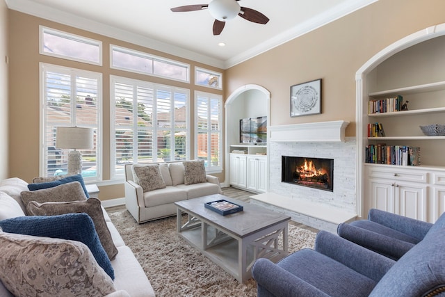 13207 Regency Oak Ln, Cypress, TX 77429 - living room with ornamental molding, a ceiling fan, a fireplace, wood finished floors, and baseboards