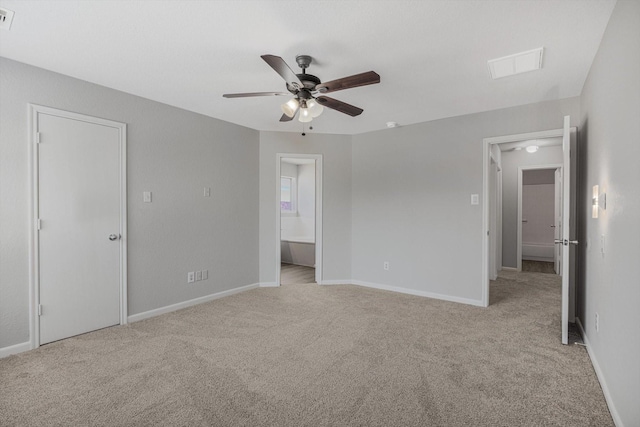 8111 Sanders Forest Ct, Humble, TX 77338 - unfurnished bedroom with light carpet, baseboards, connected bathroom, and ceiling fan