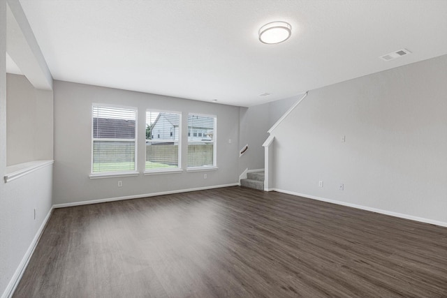 8111 Sanders Forest Ct, Humble, TX 77338 - unfurnished living room featuring dark wood-type flooring, stairs, and baseboards