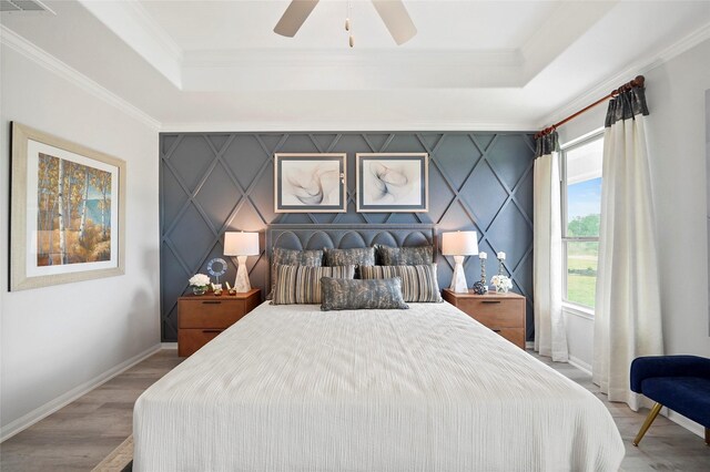 701 Barton Place Dr, Cleveland, TX 77327 - bedroom with a tray ceiling, multiple windows, wood finished floors, and crown molding