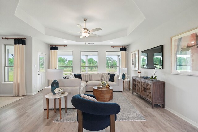 701 Barton Place Dr, Cleveland, TX 77327 - living area featuring a tray ceiling, a ceiling fan, light wood-style floors, baseboards, and recessed lighting
