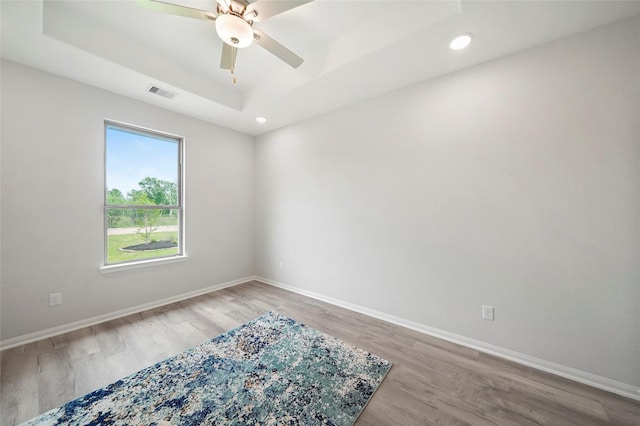 701 Barton Place Dr, Cleveland, TX 77327 - empty room with a raised ceiling, light wood-type flooring, baseboards, a ceiling fan, and recessed lighting