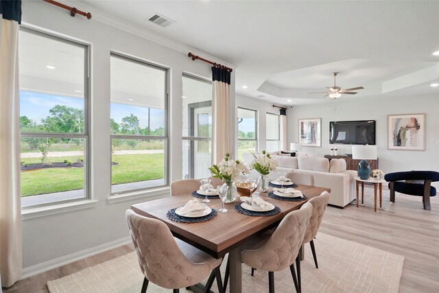 701 Barton Place Dr, Cleveland, TX 77327 - dining space featuring light wood finished floors, a ceiling fan, a tray ceiling, recessed lighting, and baseboards
