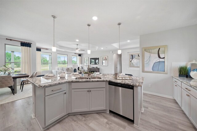 701 Barton Place Dr, Cleveland, TX 77327 - kitchen with dishwasher, a sink, open floor plan, a ceiling fan, and light stone counters