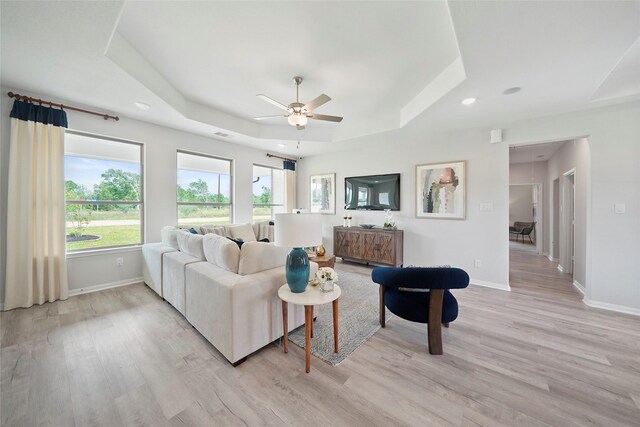 701 Barton Place Dr, Cleveland, TX 77327 - living room featuring a tray ceiling, light wood finished floors, baseboards, a ceiling fan, and recessed lighting
