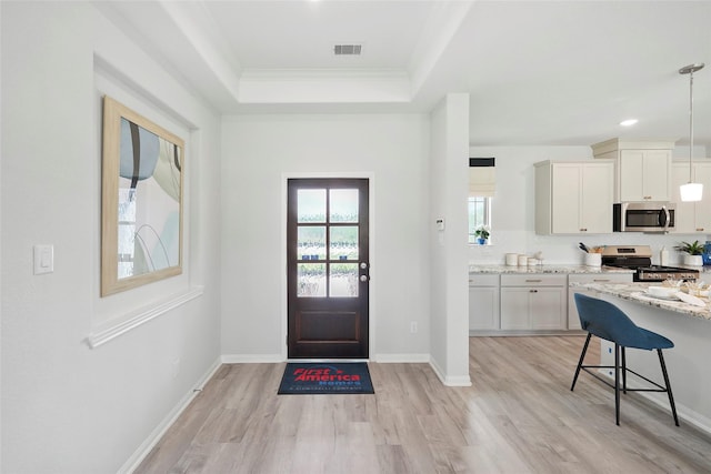 701 Barton Place Dr, Cleveland, TX 77327 - foyer entrance with light wood-type flooring, ornamental molding, a raised ceiling, baseboards, and recessed lighting