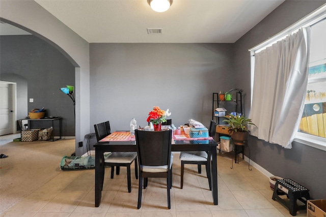 1240 Twin Estates Dr, Kyle, TX 78640 - dining space featuring arched walkways, light tile patterned floors, and baseboards