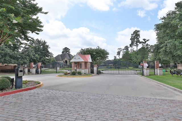 18618 Arlan Lake Dr, Spring, TX 77388 - view of decorative street featuring a gate, curbs, and a gated entry
