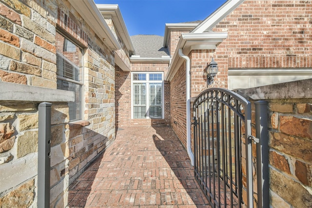 18618 Arlan Lake Dr, Spring, TX 77388 - property entrance with a gate, brick siding, and a shingled roof