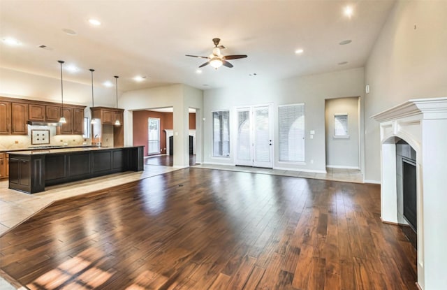 18618 Arlan Lake Dr, Spring, TX 77388 - unfurnished living room with plenty of natural light, a ceiling fan, light wood-type flooring, recessed lighting, and a fireplace