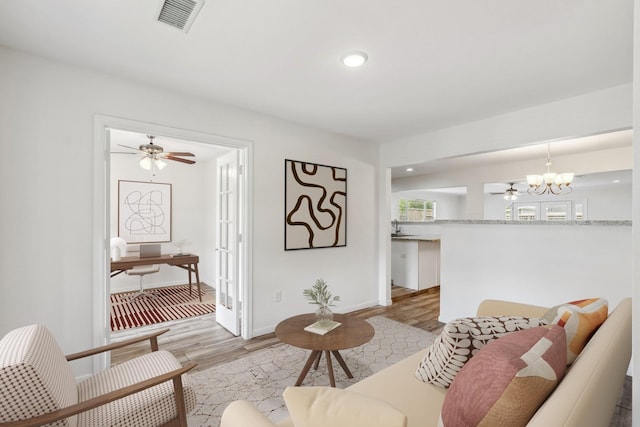 6038 Woodbrook Ln, Houston, TX 77008 - living room featuring light wood-style floors, a chandelier, ceiling fan, baseboards, and recessed lighting