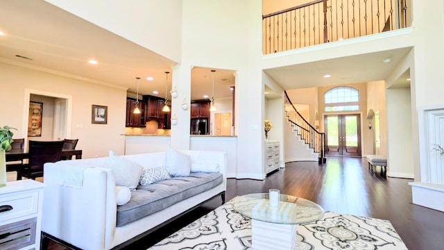 2530 Sparrow Crest Dr, Katy, TX 77494 - living area featuring stairs, dark wood-style floors, crown molding, a towering ceiling, and baseboards