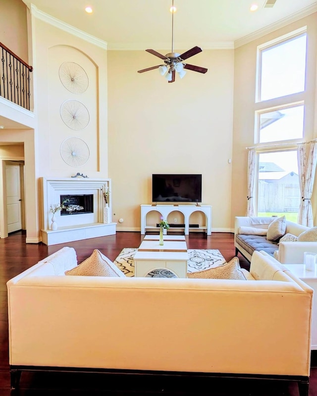 2530 Sparrow Crest Dr, Katy, TX 77494 - living area featuring a high ceiling, ceiling fan, dark wood-type flooring, crown molding, and baseboards