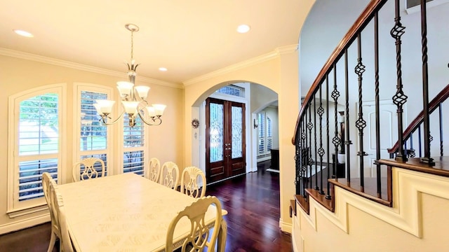 2530 Sparrow Crest Dr, Katy, TX 77494 - dining space featuring arched walkways, a chandelier, stairway, french doors, and dark wood finished floors