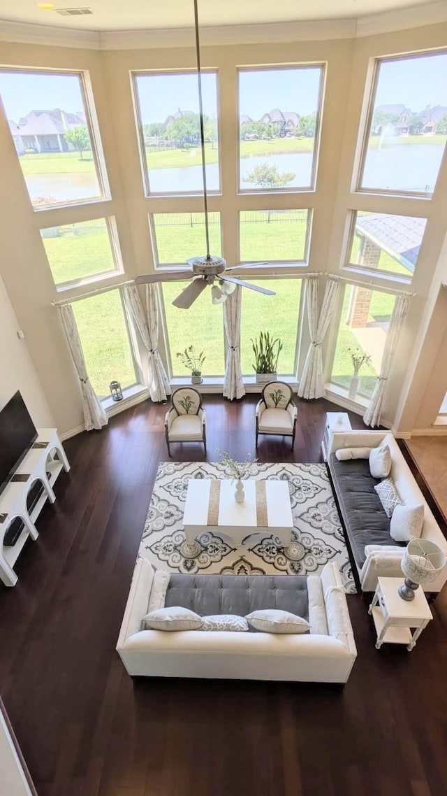 2530 Sparrow Crest Dr, Katy, TX 77494 - living area with a water view, a towering ceiling, wood finished floors, a ceiling fan, and crown molding