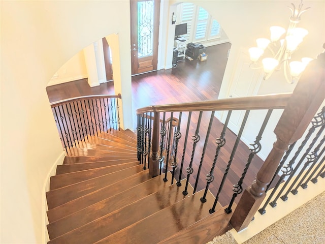 2530 Sparrow Crest Dr, Katy, TX 77494 - stairs with wood finished floors, a chandelier, and arched walkways