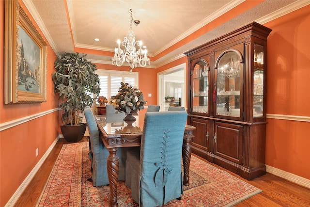 6235 Queenswood Ln, Houston, TX 77008 - dining area with a chandelier, wood finished floors, ornamental molding, and baseboards