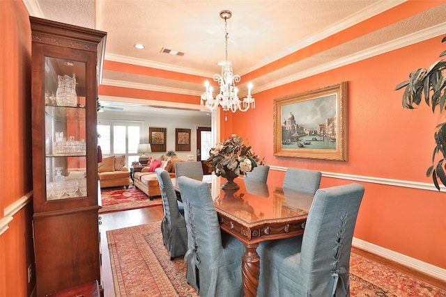 6235 Queenswood Ln, Houston, TX 77008 - dining area with wood finished floors, a chandelier, and crown molding