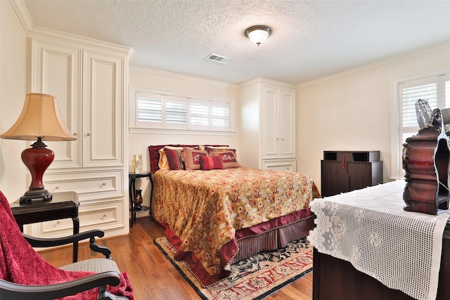 6235 Queenswood Ln, Houston, TX 77008 - bedroom featuring multiple windows, wood finished floors, ornamental molding, and a textured ceiling