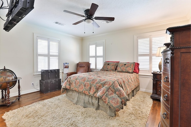 6235 Queenswood Ln, Houston, TX 77008 - bedroom featuring wood finished floors, crown molding, baseboards, and ceiling fan