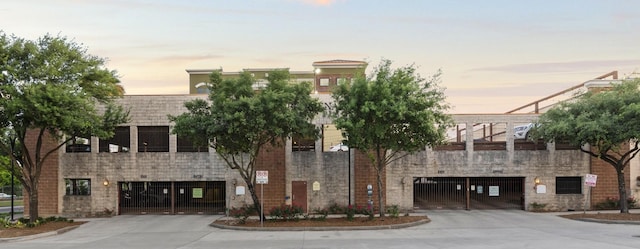 2323 Polk St Unit 302, Houston, TX 77003 - property at dusk featuring concrete driveway