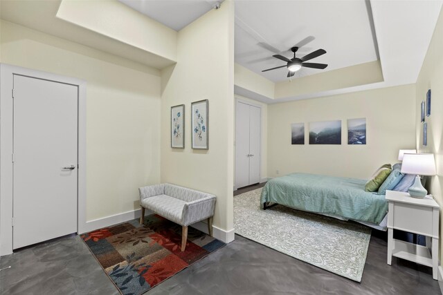 2323 Polk St Unit 302, Houston, TX 77003 - bedroom featuring ceiling fan, a tray ceiling, and baseboards