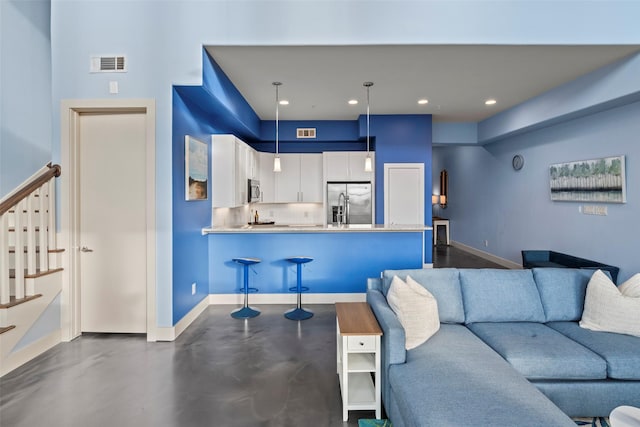 2323 Polk St Unit 302, Houston, TX 77003 - living area with stairway, baseboards, and recessed lighting