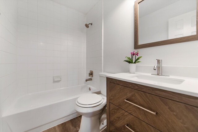 31115 Perlican Dr, Spring, TX 77386 - bathroom featuring toilet, wood finished floors, vanity, and bathing tub / shower combination