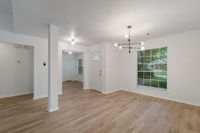 31115 Perlican Dr, Spring, TX 77386 - spare room with a chandelier, light wood-style floors, and baseboards