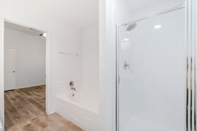 31115 Perlican Dr, Spring, TX 77386 - bathroom featuring a stall shower, wood finished floors, and a bath